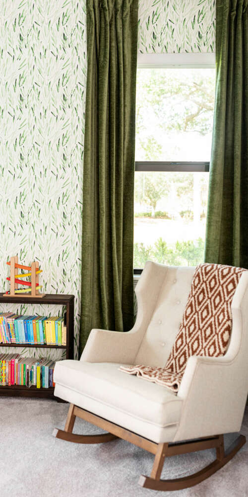 white rocking chair next to small bookshelf