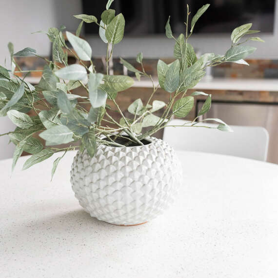 White vase on top of white dining table