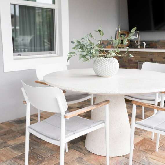 White dining table and chairs-bricks inn-ceiling fan