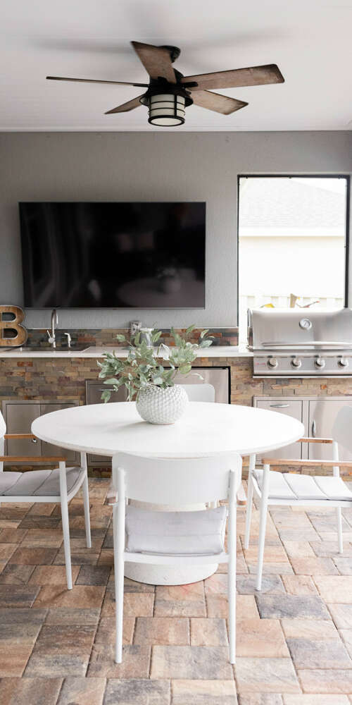 White dining table and chairs-bricks inn-ceiling fan