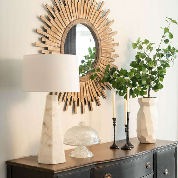 Light walls dining room-White dining table with dark chairs-dark curtains-dark furtinure-gold frame circle shape mirror-ashen wood floor-ceiling hanging lamp