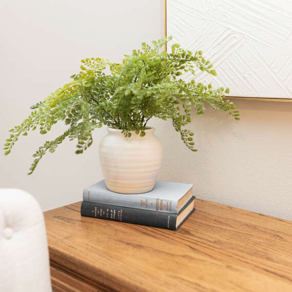 wood desk-white vase with plant-light wall