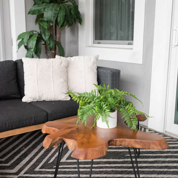 dark outside furniture on top of geometrical carpet and wood coffe table